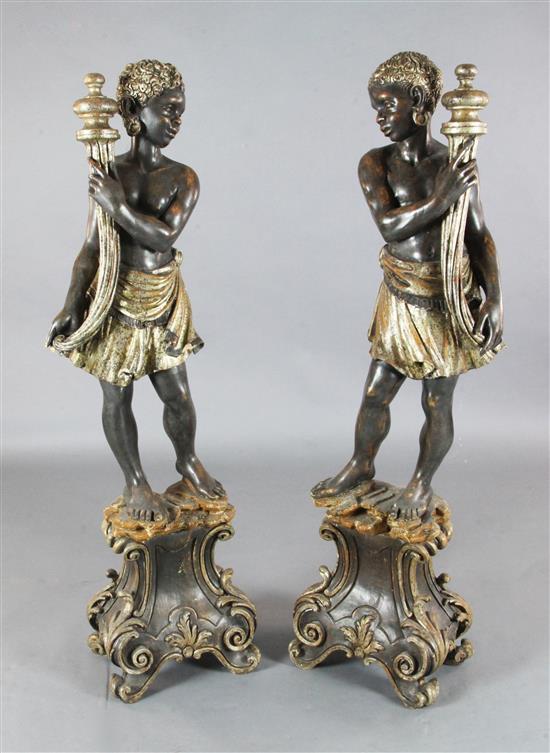 A pair of Italian parcel silvered painted wood blackamoors, H.4ft 4in.